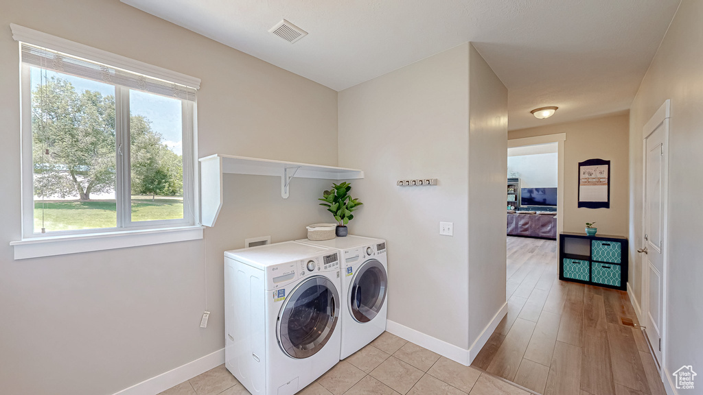 Laundry room featuring independent washer and dryer and plenty of natural light