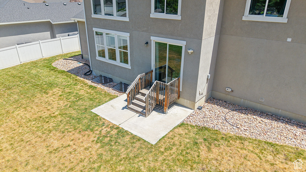 Entrance to property featuring stucco siding and a patio area