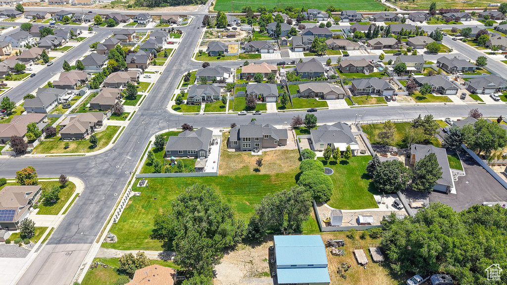 Aerial view of property and surrounding area with nearby suburban area