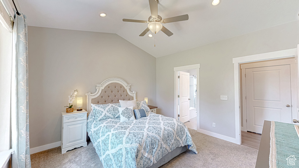 Bedroom with light colored carpet, vaulted ceiling, ensuite bath, ceiling fan, and recessed lighting