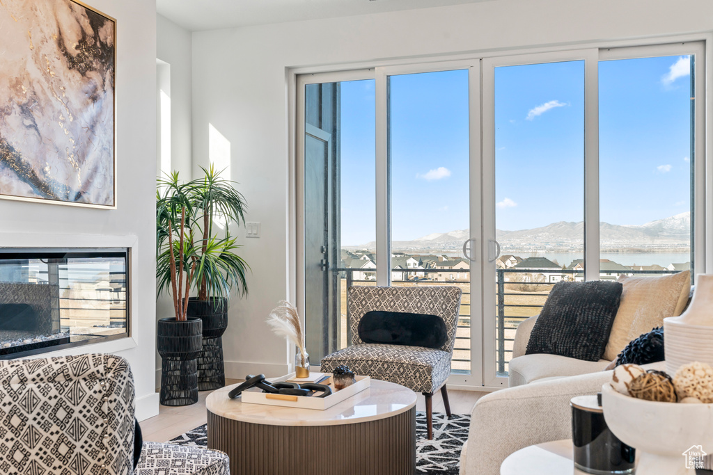 Sitting room with healthy amount of natural light, wood finished floors, and a mountain view