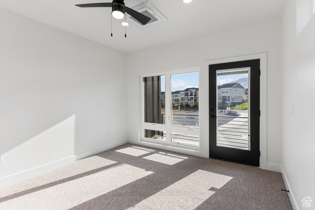 Spare room with carpet floors and ceiling fan