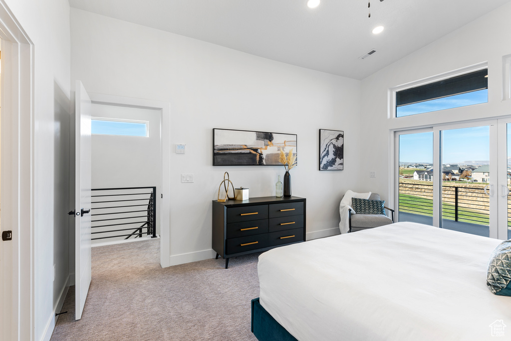 Bedroom featuring light carpet, multiple windows, access to exterior, and recessed lighting