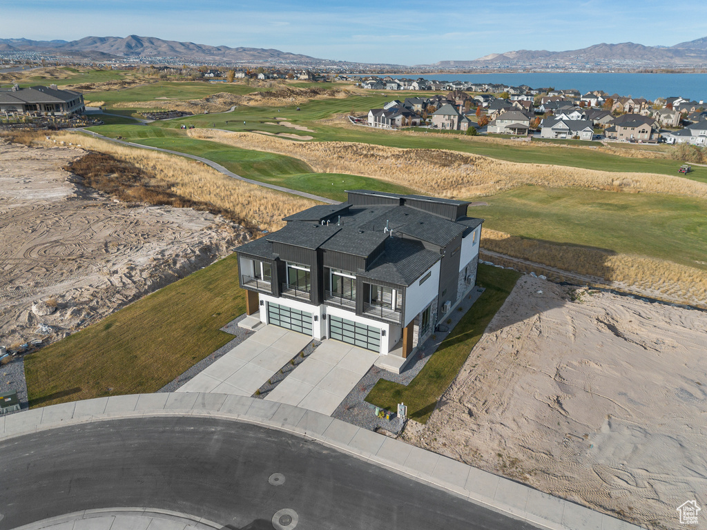 Aerial view of residential area featuring a water and mountain view and a local golf course