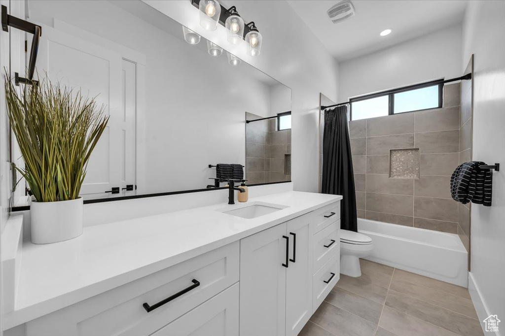 Bathroom featuring vanity, shower / tub combo, tile patterned floors, and recessed lighting