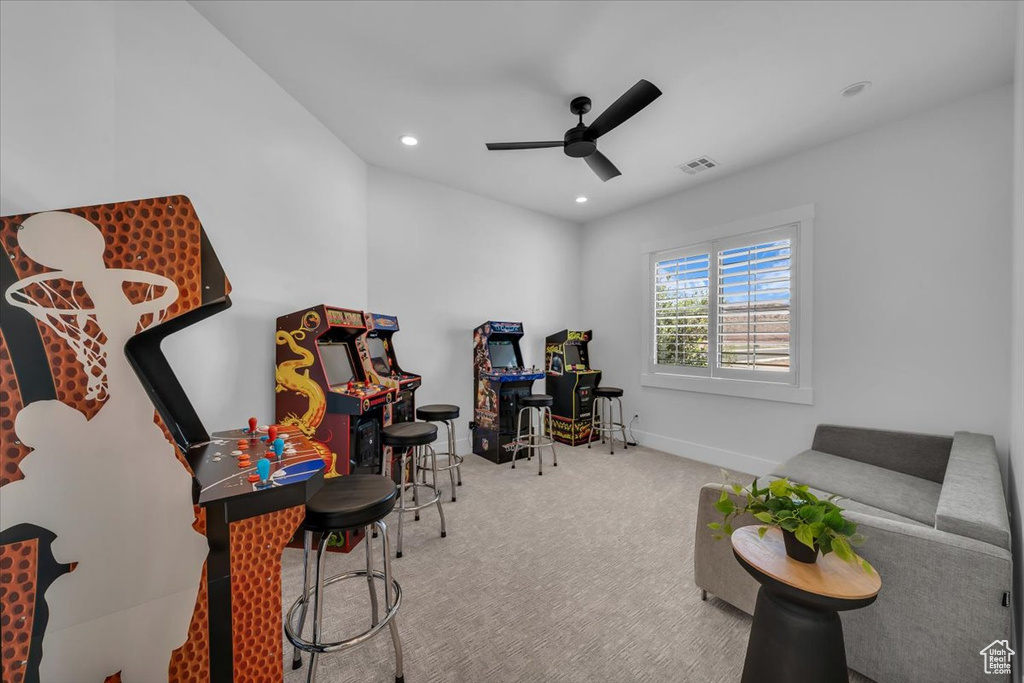 Recreation room with a ceiling fan, carpet floors, and recessed lighting