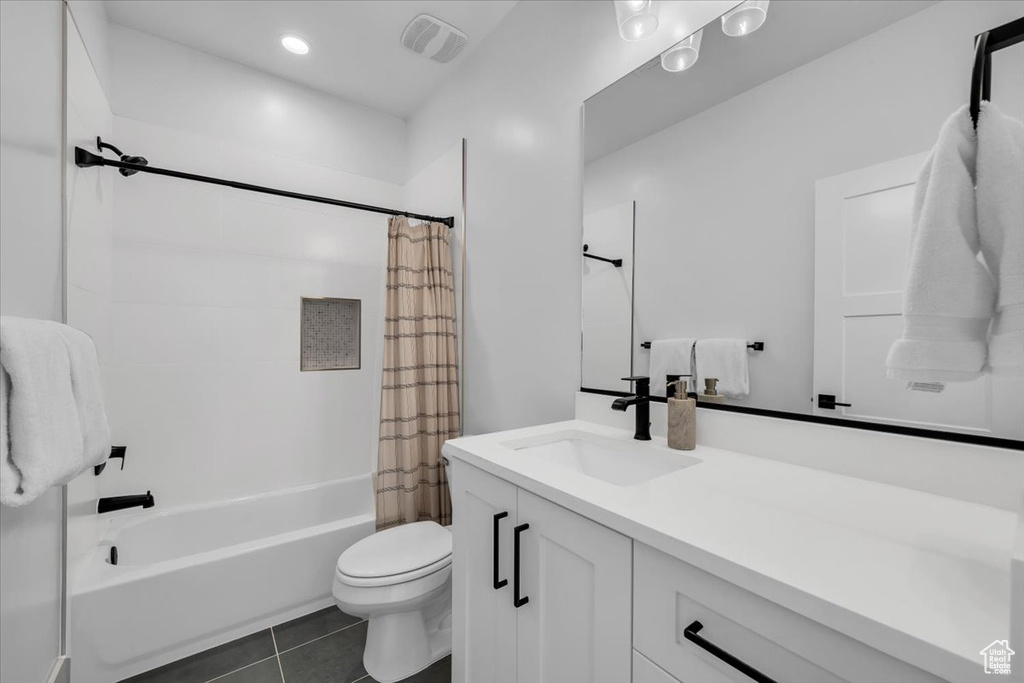 Full bathroom featuring vanity, tile patterned floors, and shower / bath combination with curtain