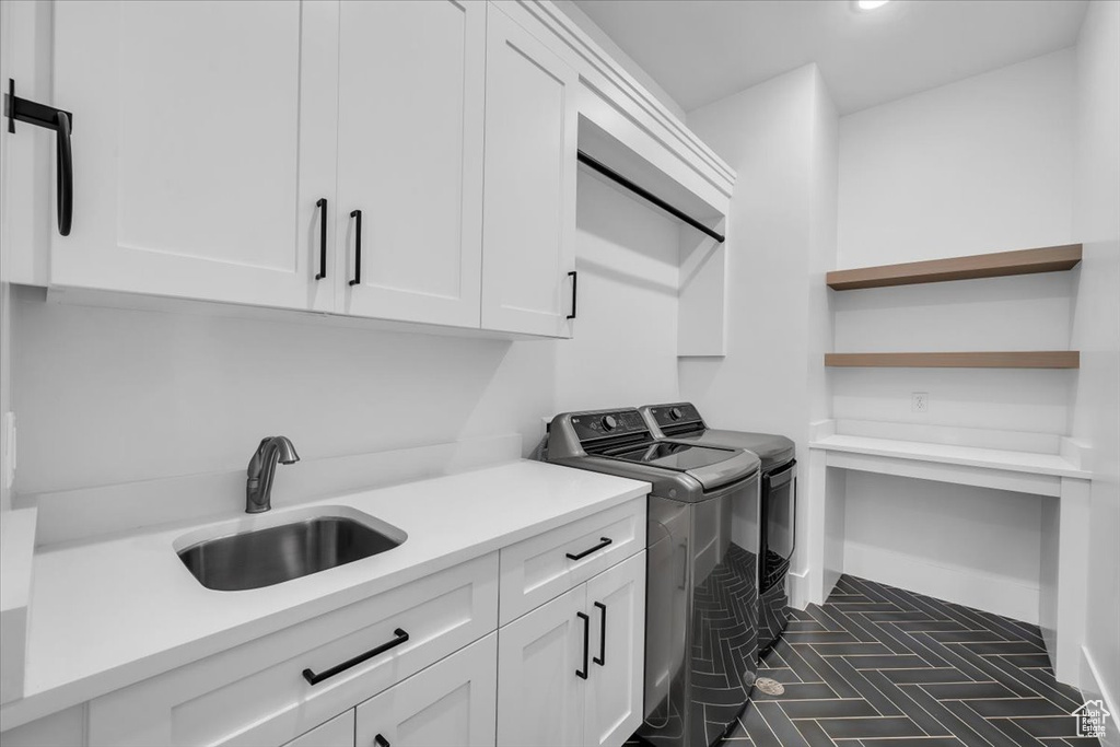 Laundry room with cabinet space, washing machine and clothes dryer, and recessed lighting