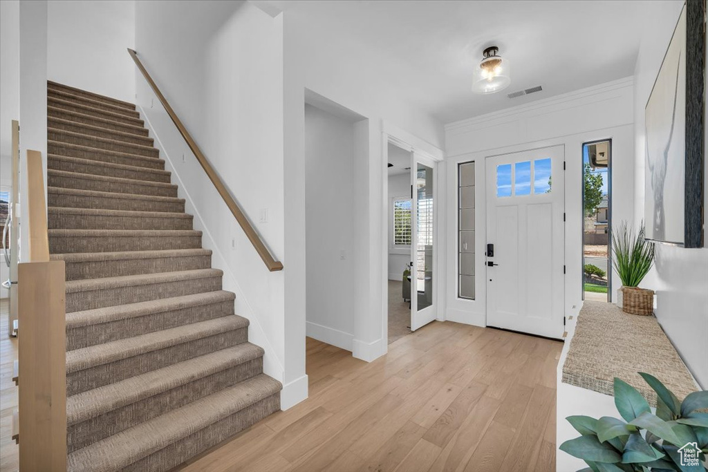 Entryway with stairway and light wood-style flooring