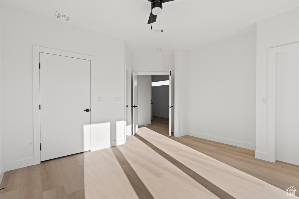Unfurnished bedroom with light wood-type flooring and a ceiling fan