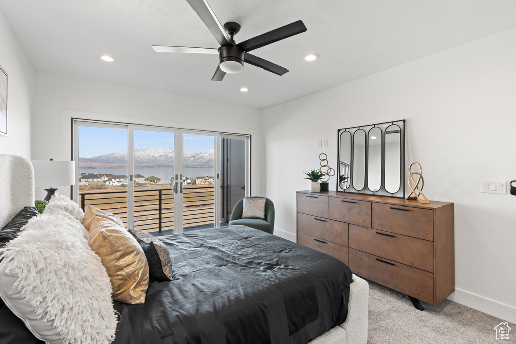 Bedroom featuring access to exterior, light carpet, recessed lighting, a ceiling fan, and a mountain view