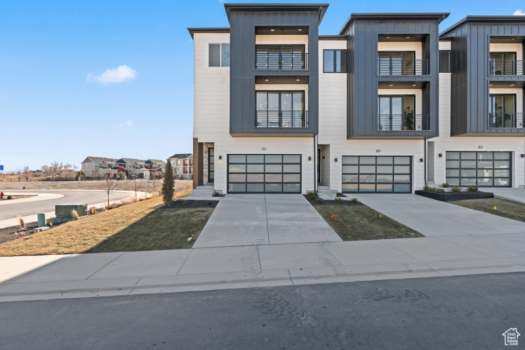 Contemporary home featuring an attached garage and driveway