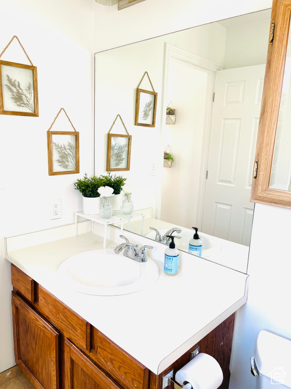 Bathroom featuring vanity and toilet