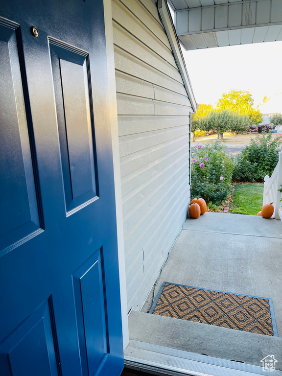 View of exterior entry with a patio