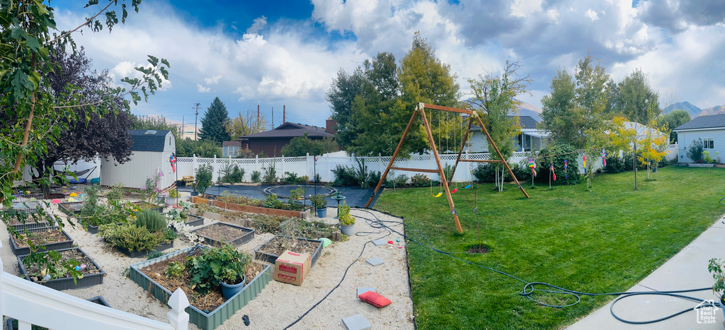 View of yard with a garden and a storage shed