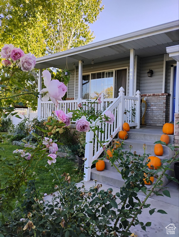 View of exterior entry with covered porch