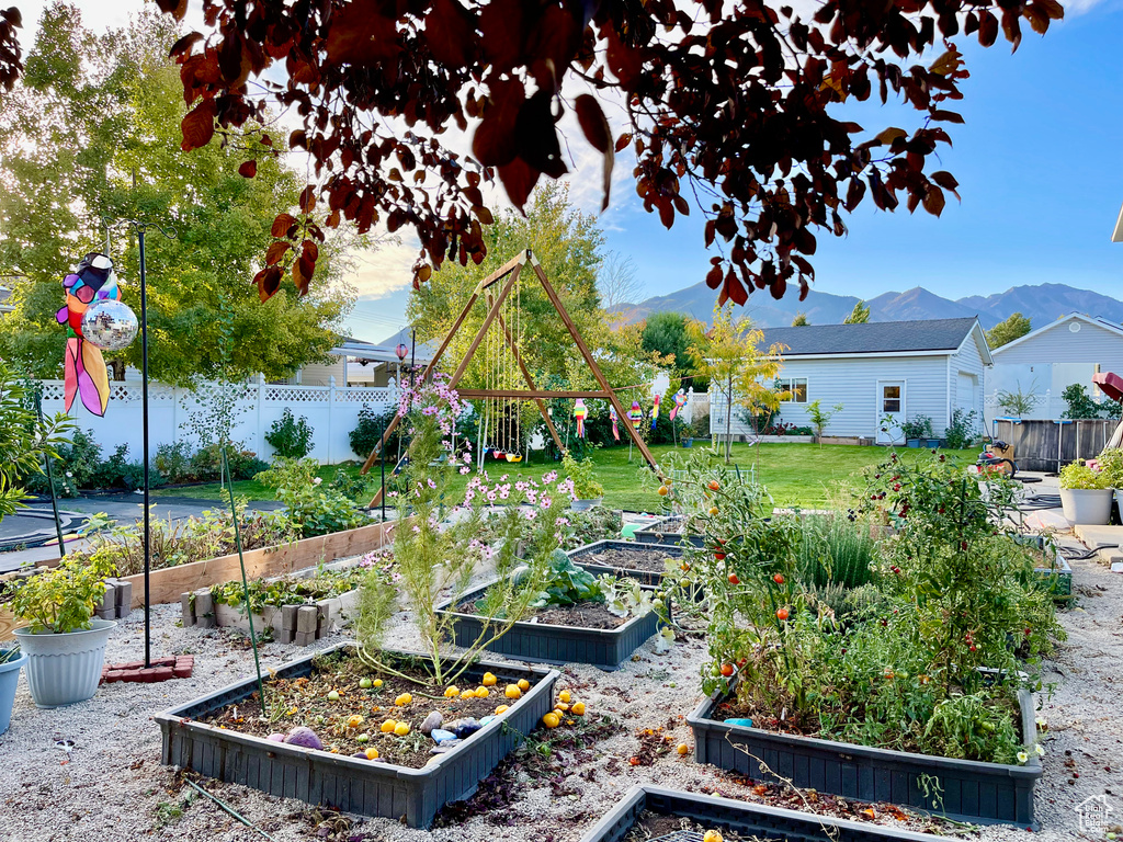 View of yard featuring a vegetable garden and a mountain view