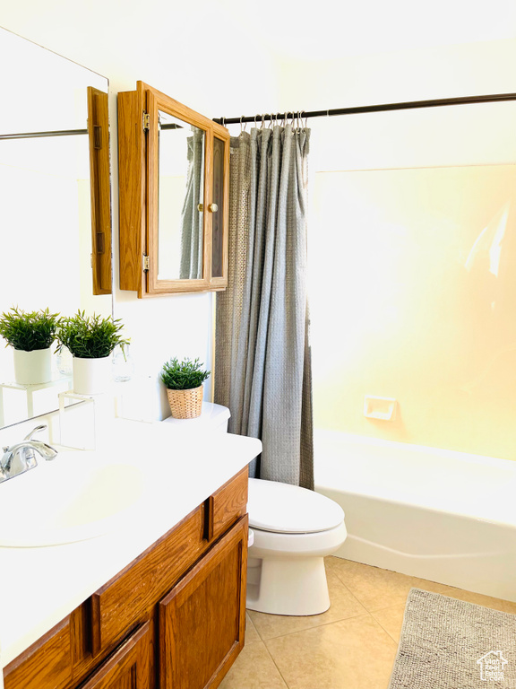 Full bathroom featuring vanity, tile patterned floors, and shower / tub combo with curtain