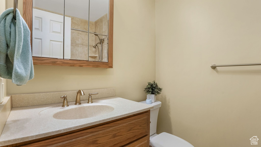 Bathroom featuring vanity and tiled shower