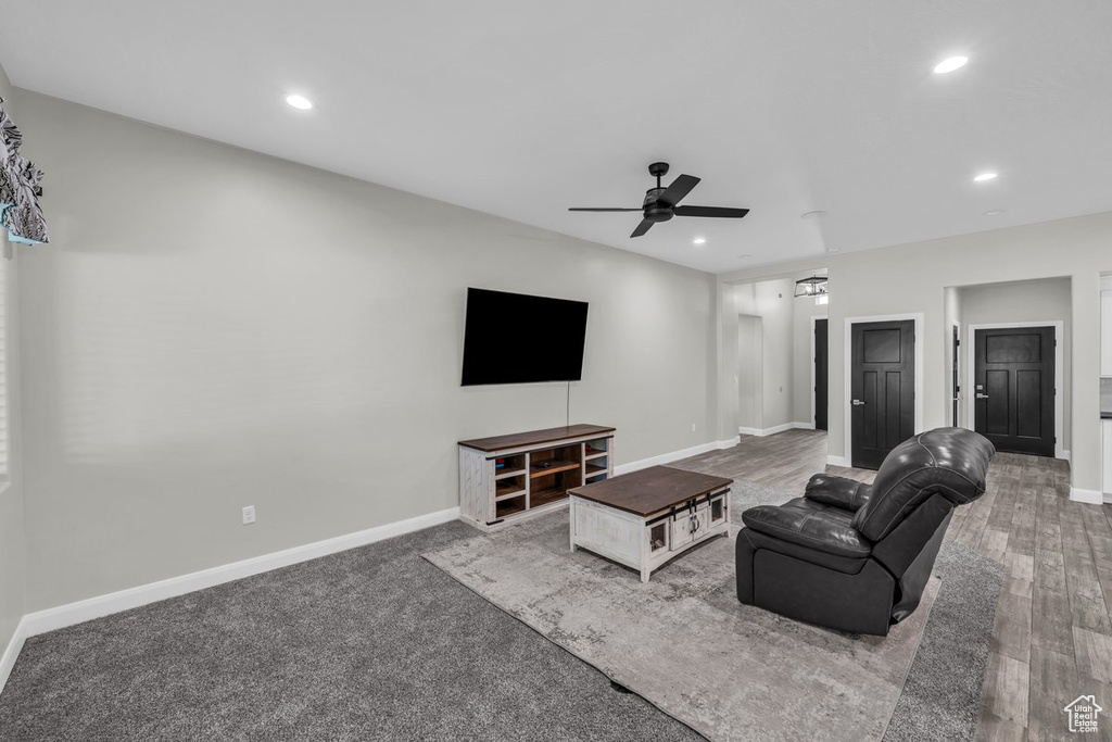 Living room with a ceiling fan, recessed lighting, and wood finished floors