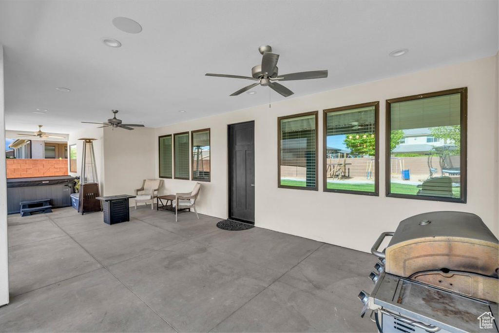 View of patio / terrace with a hot tub, a ceiling fan, a grill, and outdoor lounge area