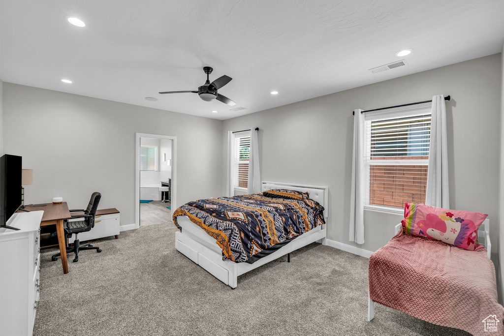 Carpeted bedroom featuring an office area, multiple windows, recessed lighting, and ceiling fan