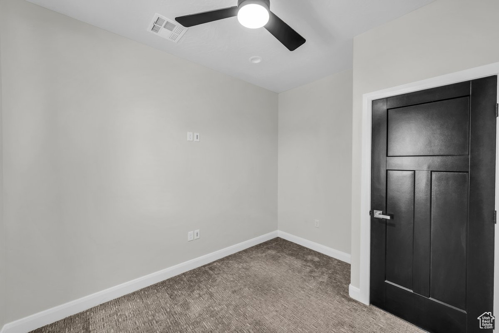 Unfurnished bedroom featuring carpet floors and ceiling fan
