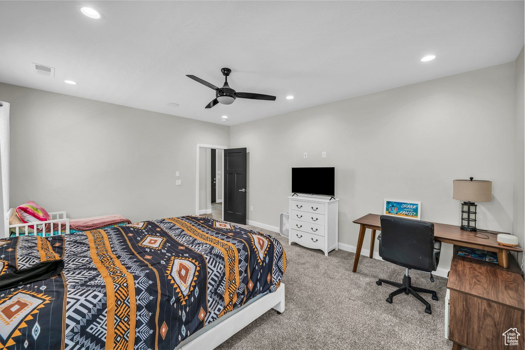 Carpeted bedroom with recessed lighting and a ceiling fan