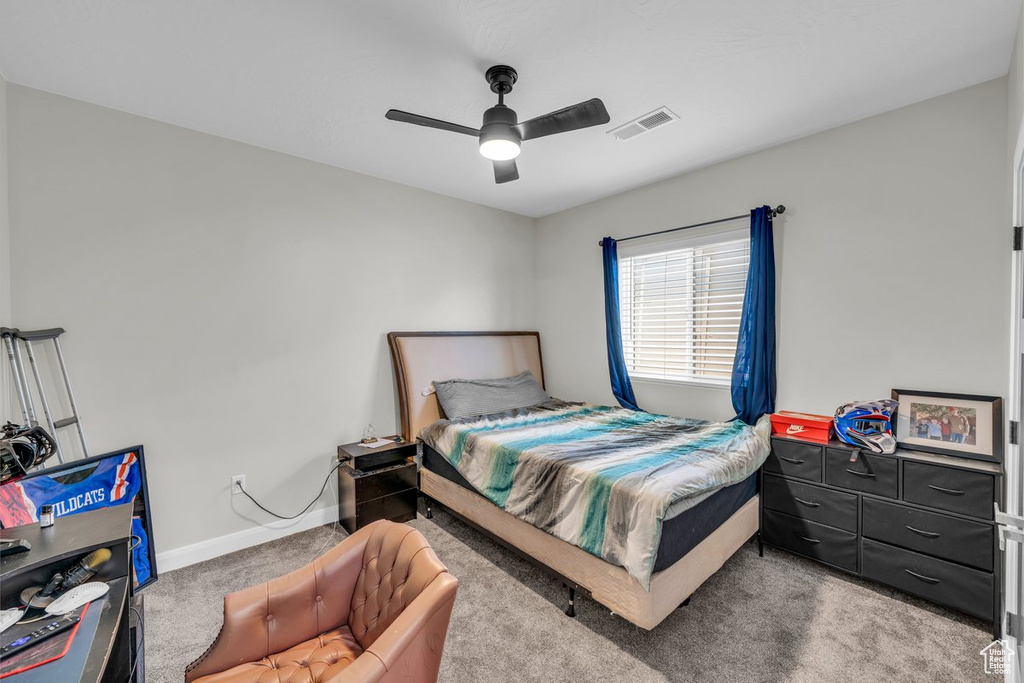 Bedroom with carpet and a ceiling fan