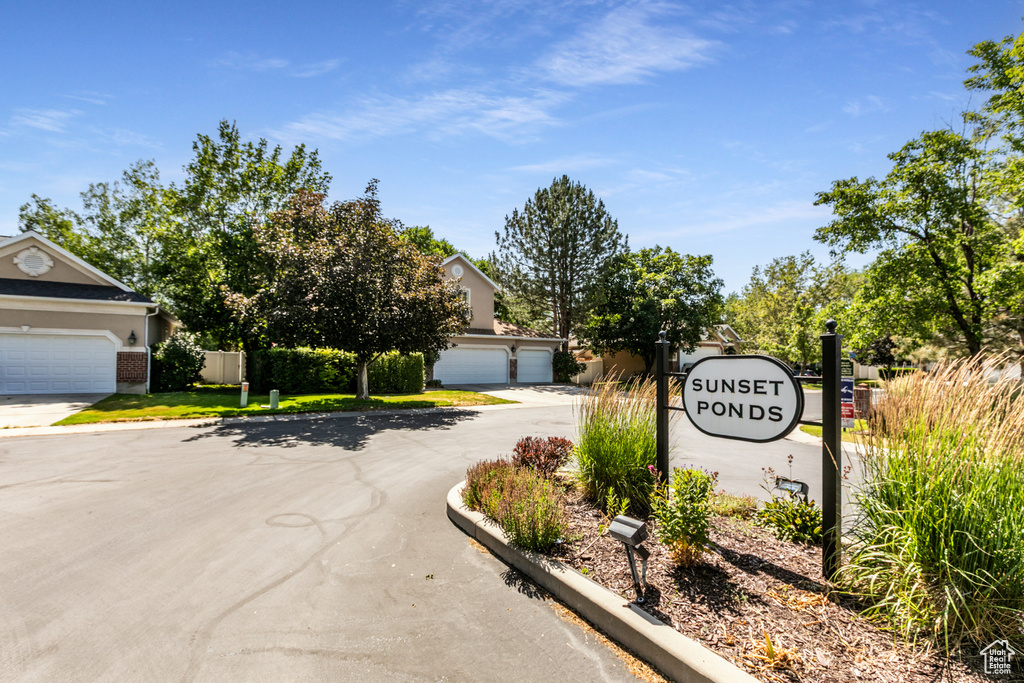 Community sign featuring a garage and driveway