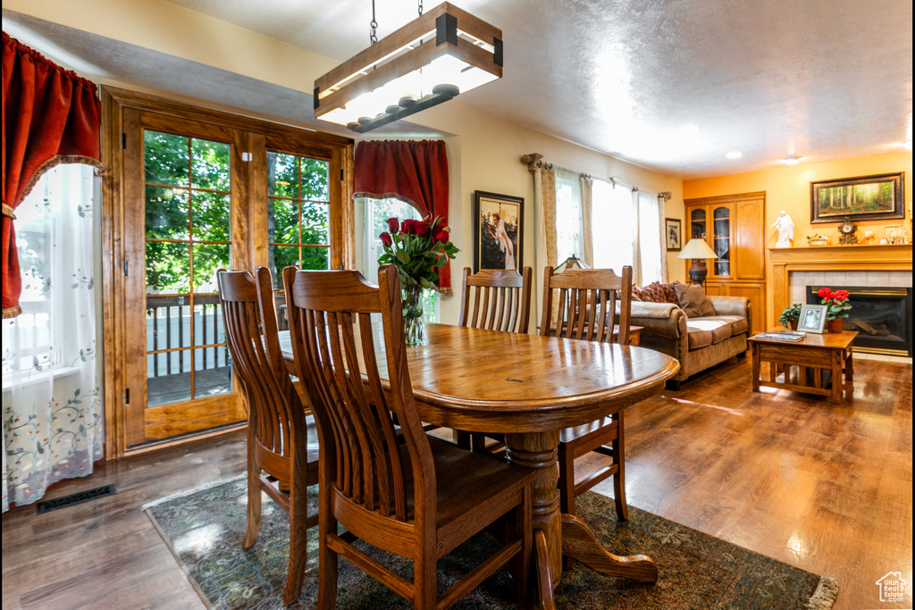 Dining area featuring wood finished floors and a fireplace
