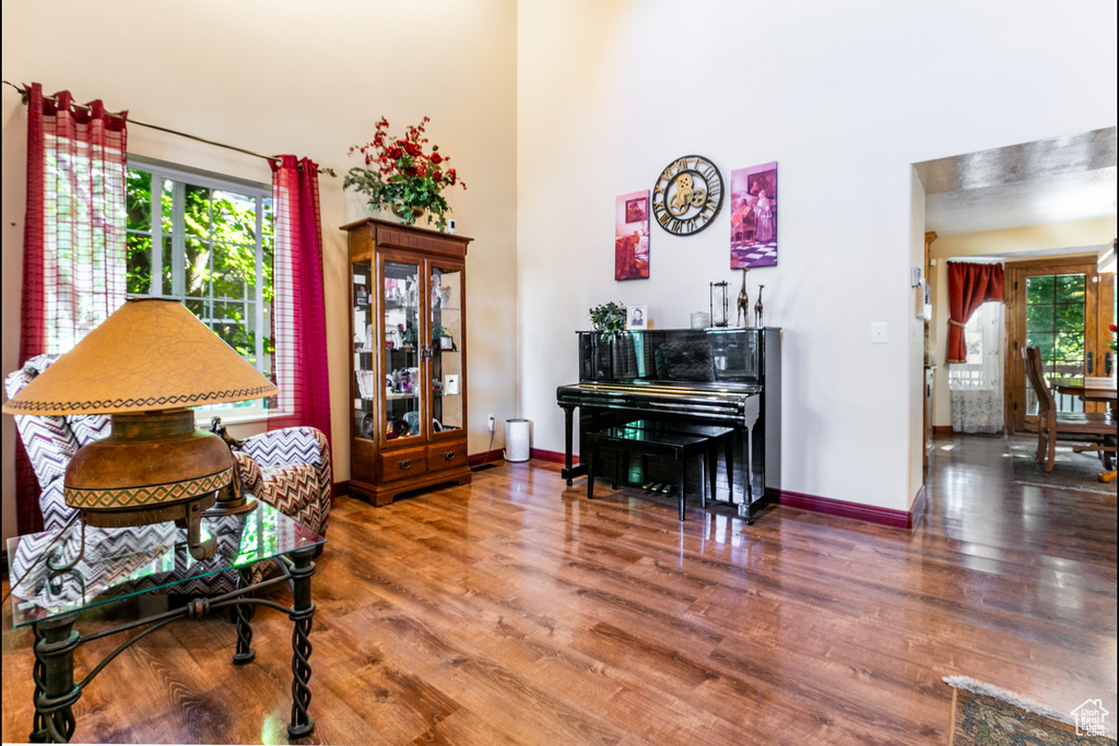 Living area with wood finished floors and a high ceiling