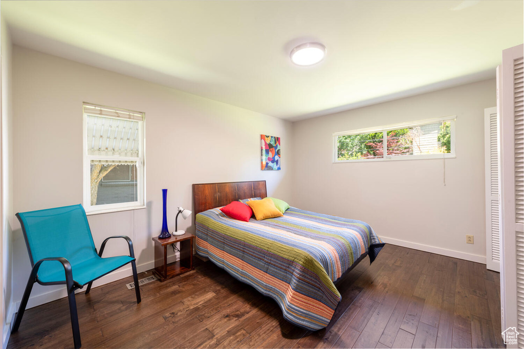 Bedroom with dark wood-type flooring