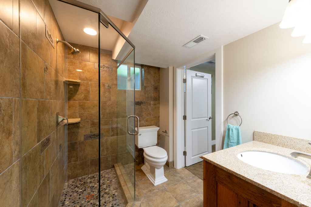 Bathroom with a stall shower and vanity
