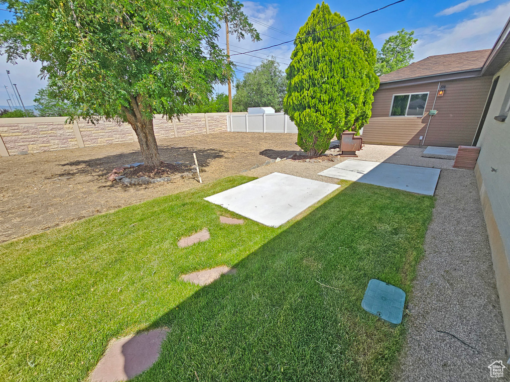 Fenced backyard with a patio
