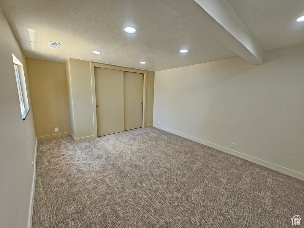 Unfurnished bedroom featuring carpet floors, recessed lighting, a textured ceiling, and a closet