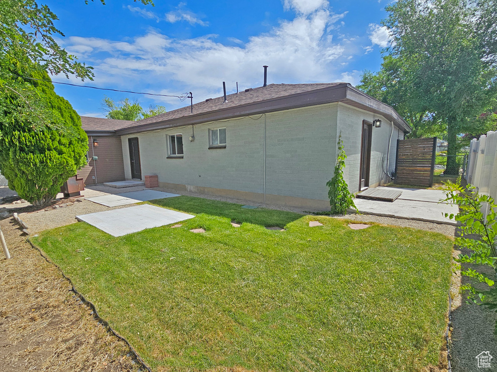 Rear view of house with brick siding and a patio