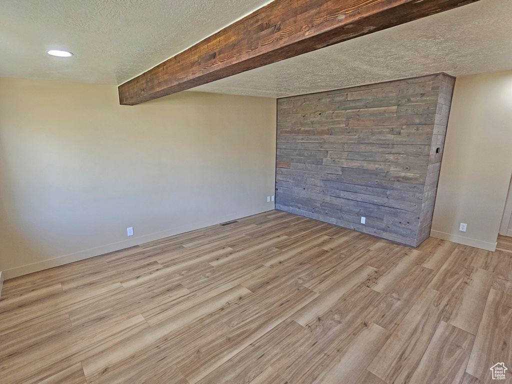 Spare room with a textured ceiling, light wood finished floors, and recessed lighting