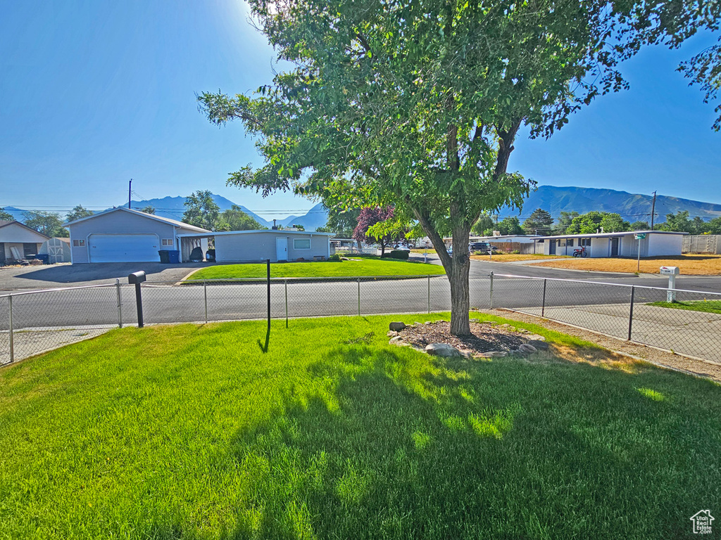 View of yard with a mountain view and concrete driveway