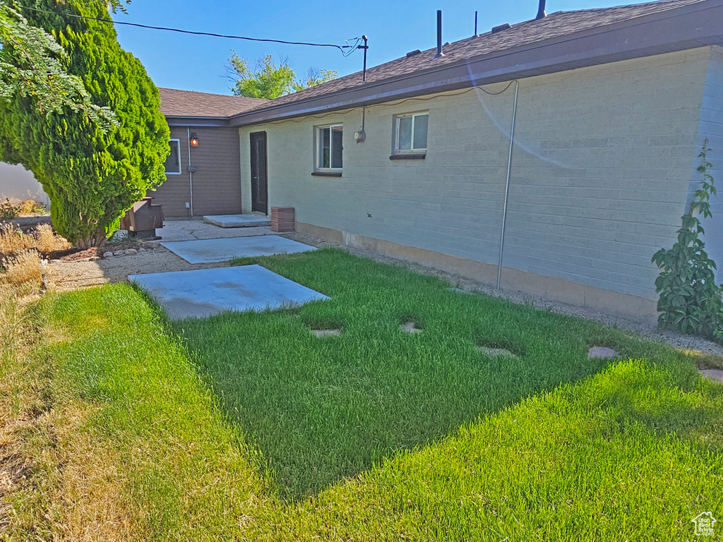 View of green lawn featuring a patio area