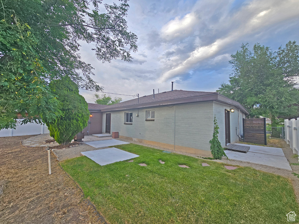 Rear view of house featuring a patio and brick siding