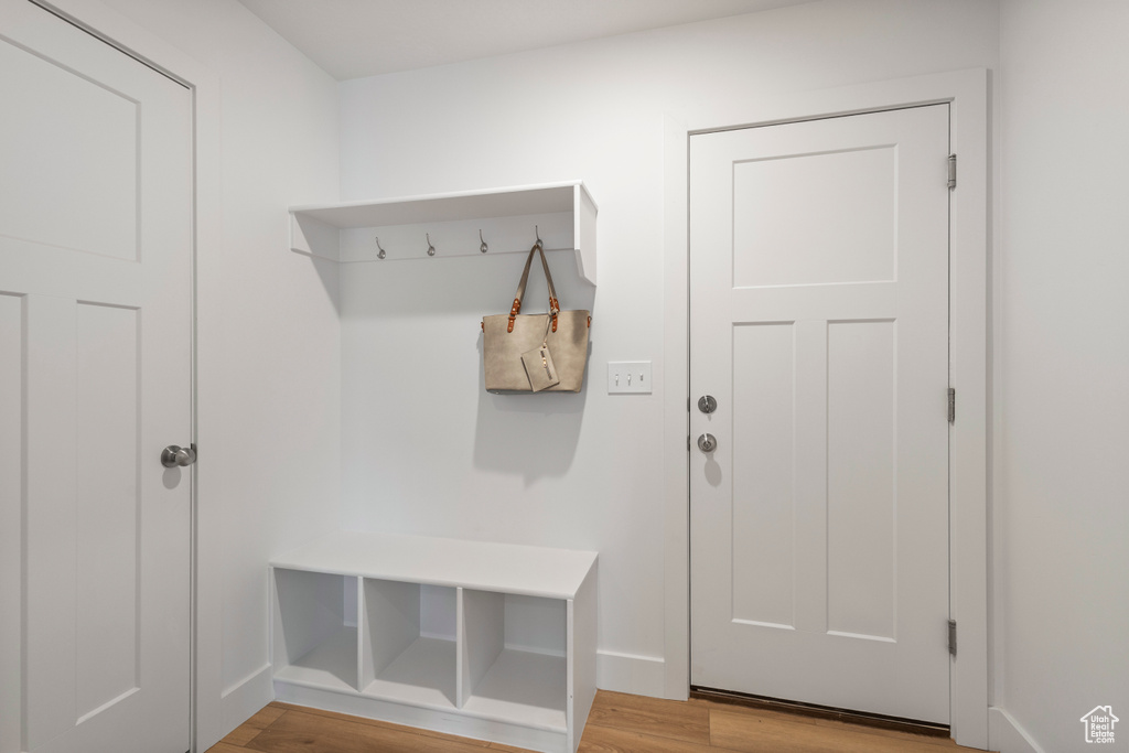Mudroom featuring wood finished floors and baseboards