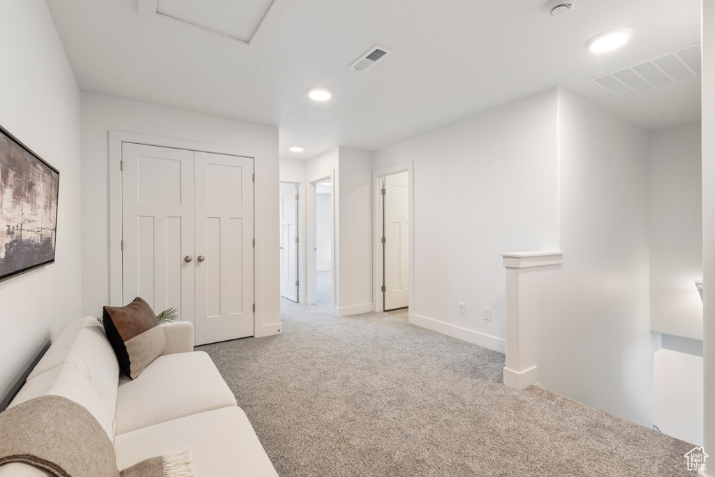 Living room with light carpet and recessed lighting