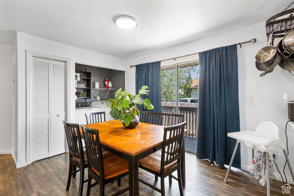 Dining space featuring washing machine and dryer and dark wood-type flooring