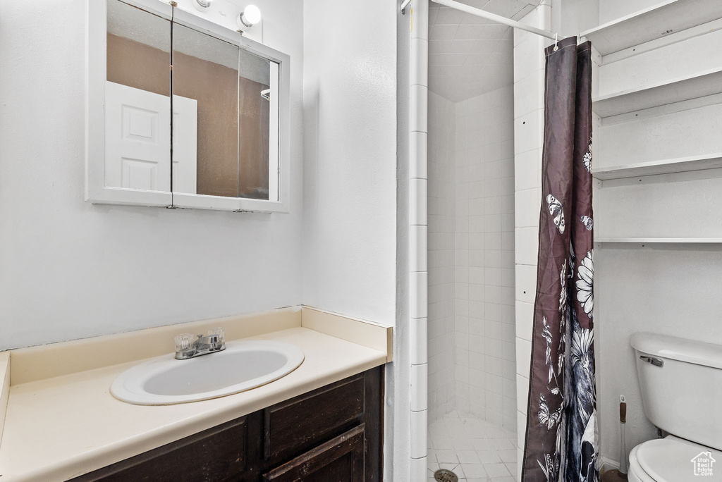 Full bath with vanity and a shower stall