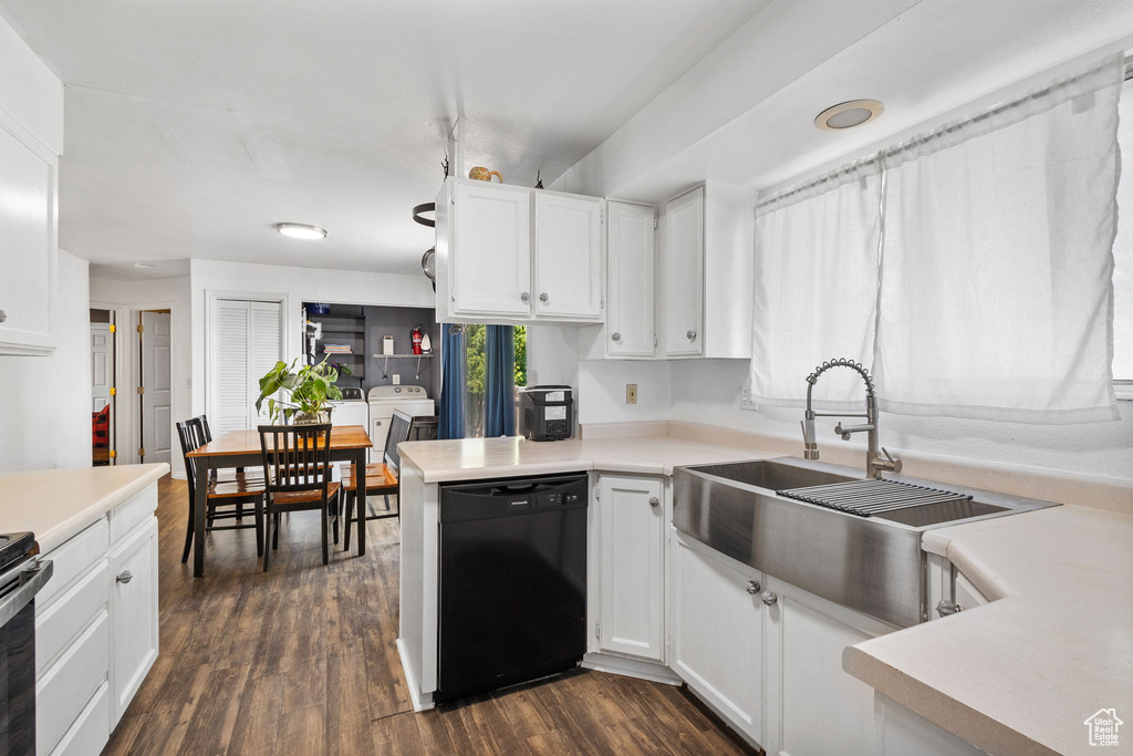 Kitchen with dishwasher, white cabinetry, dark wood-type flooring, and light countertops