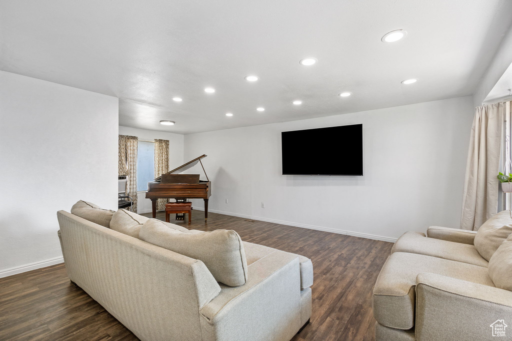 Living room featuring recessed lighting and dark wood-style flooring