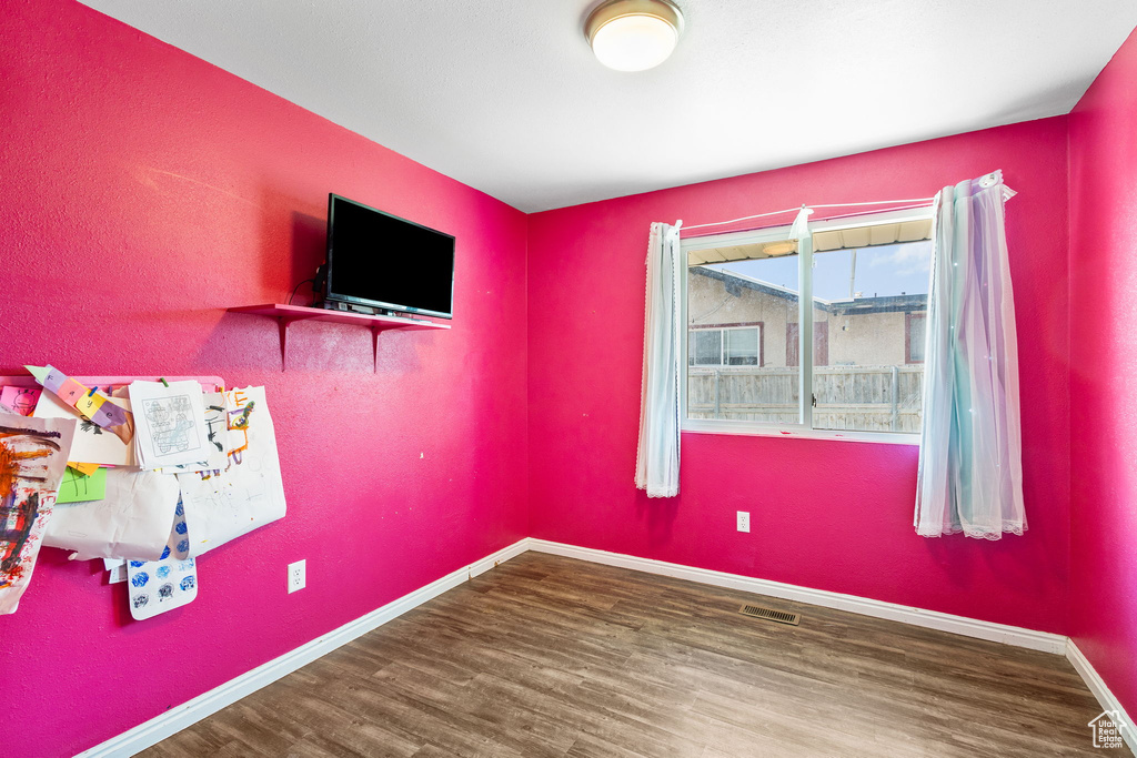 Empty room with wood finished floors and baseboards