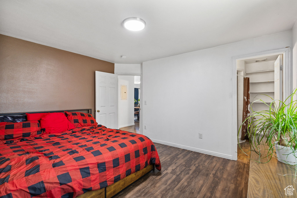 Bedroom featuring wood finished floors and baseboards