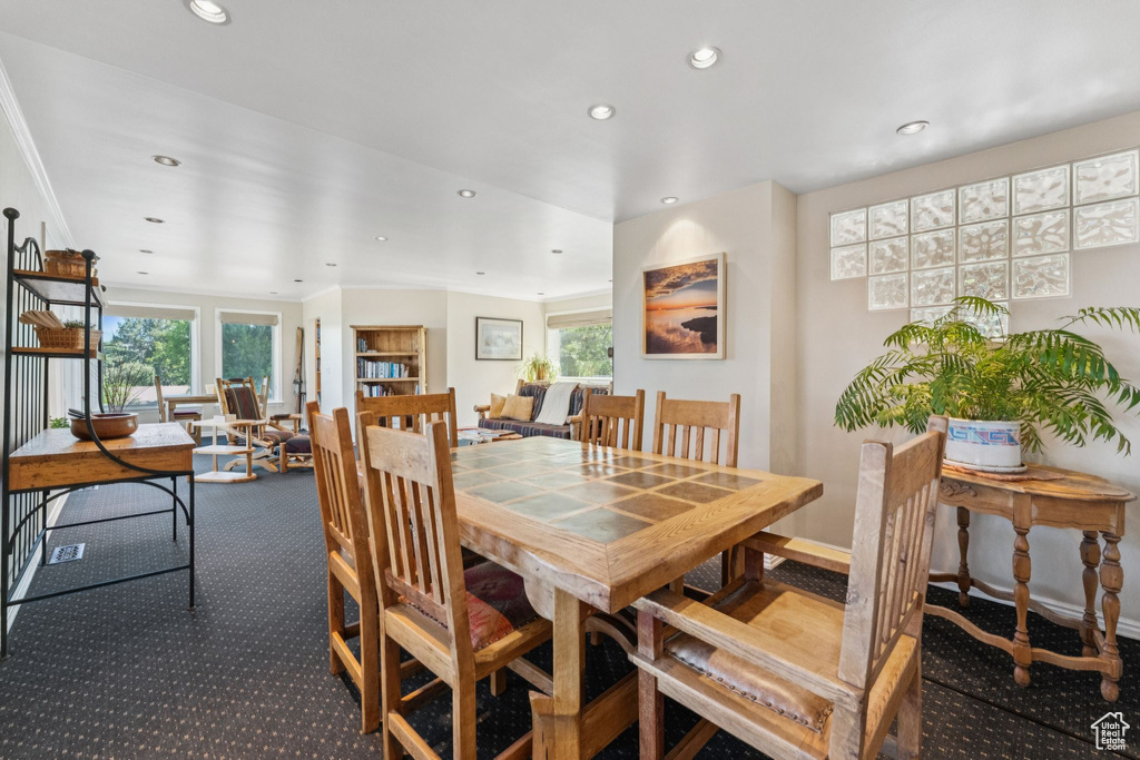 Dining room with recessed lighting and carpet